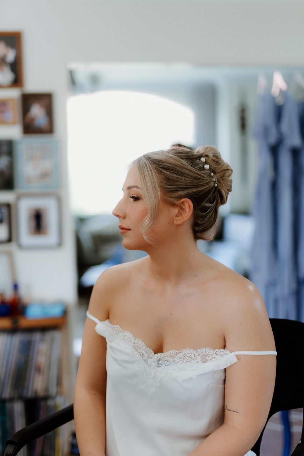 An elegant bride in a white lace dress with her hair styled in a classic updo.