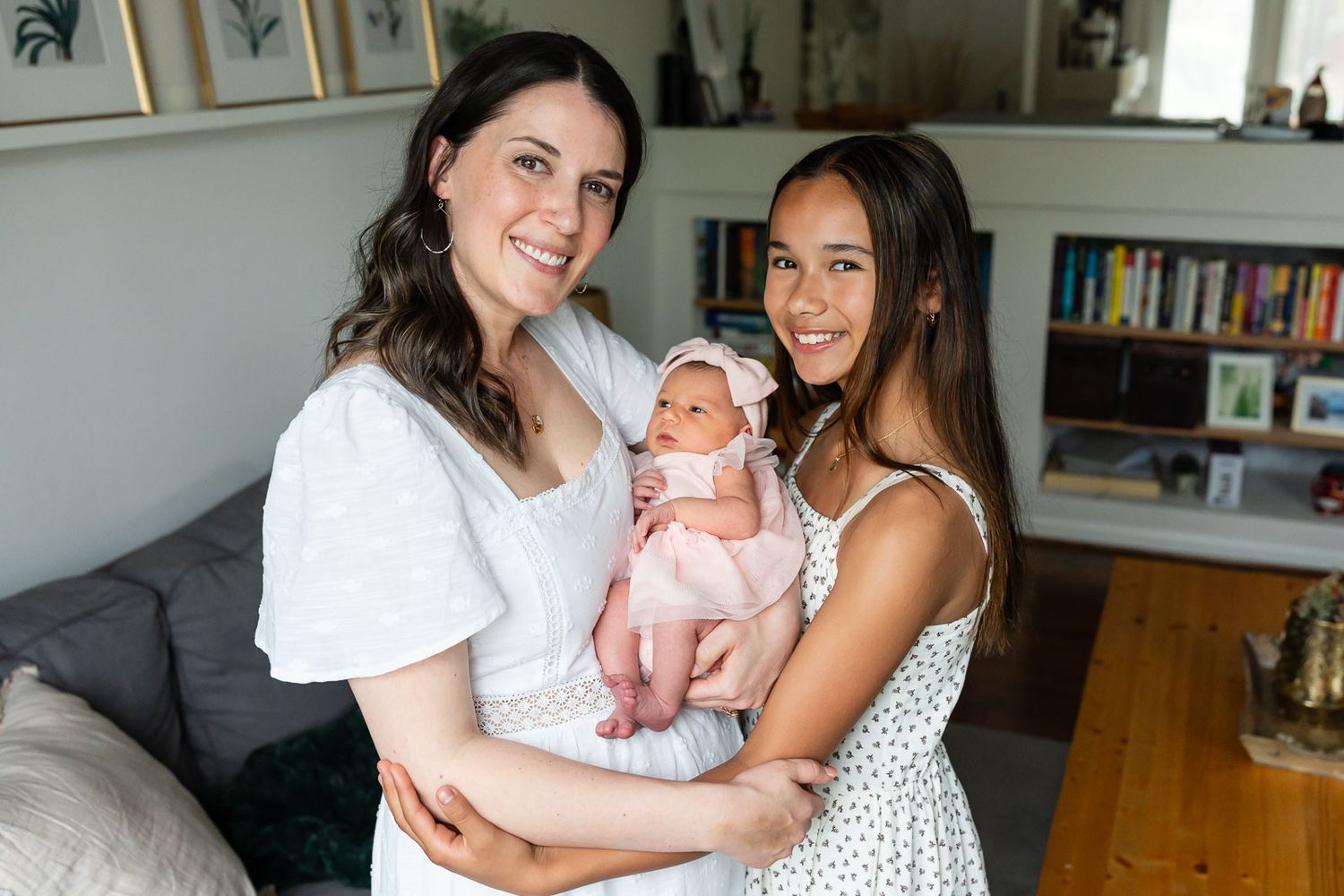 Mom posing for portrait with her daughters.