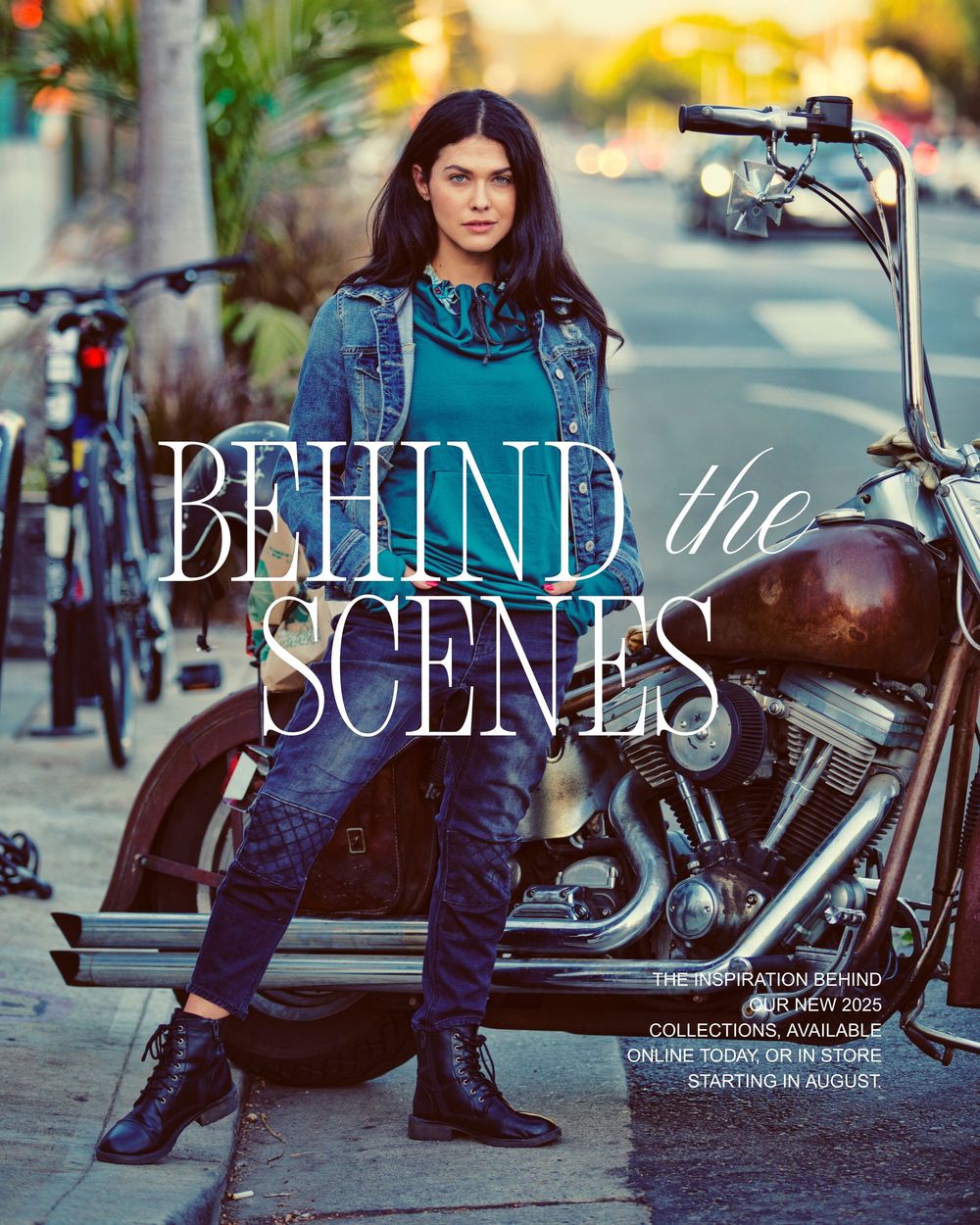 A woman in a denim jacket poses confidently beside a Harley-Davidson motorcycle for a Behind the Scenes fashion campaign.