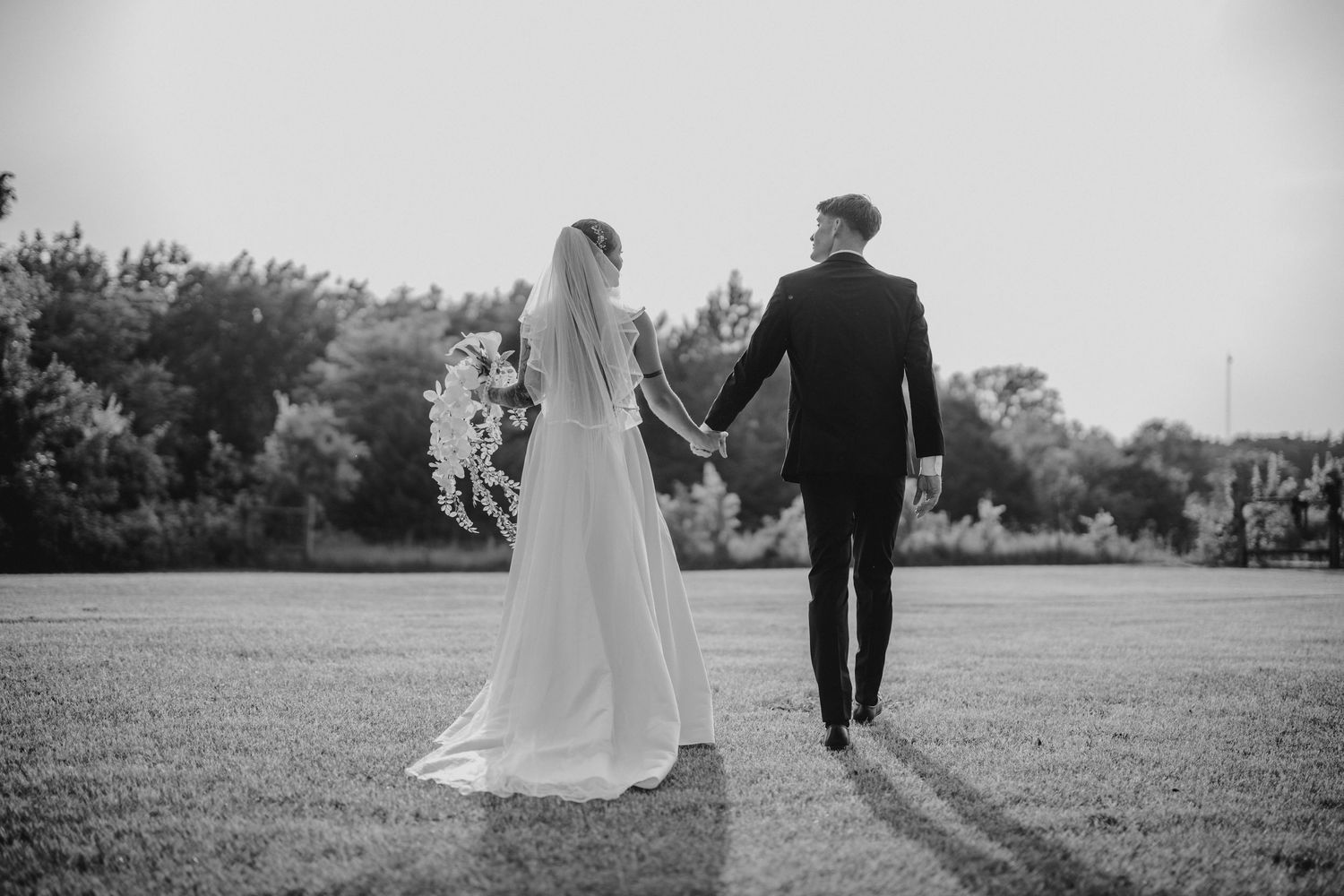Romantic couple sharing an intimate moment together at a dimly lit venue, dressed in elegant evening attire.