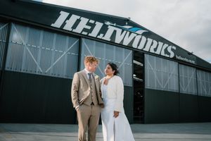 Queenstown bride and groom share a romantic moment outside the Heliworks hangar on their wedding day.