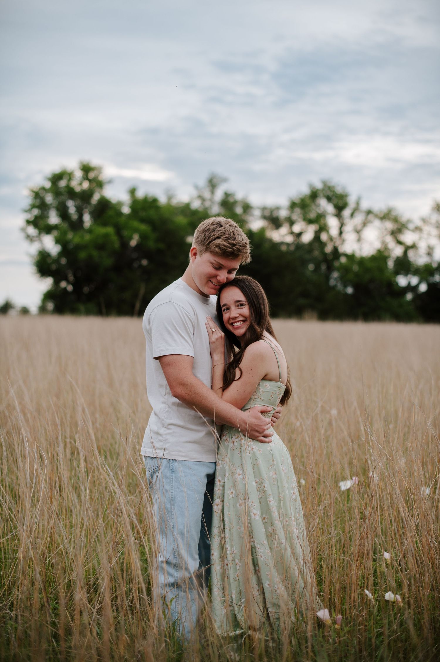 Wichita KS outdoor engagement photos in nature location Andover, couple photos in field with flowers, small elopement wedding photographer