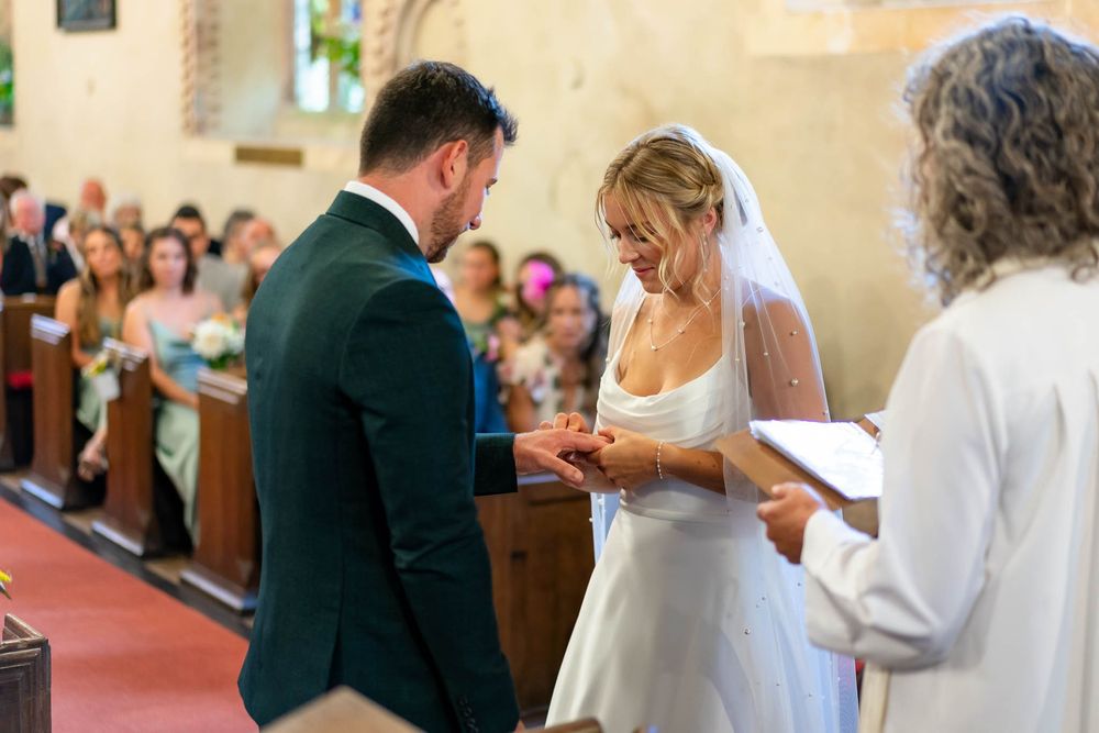 Bride and Groom exchange rings in Stoodleigh Church Wedding