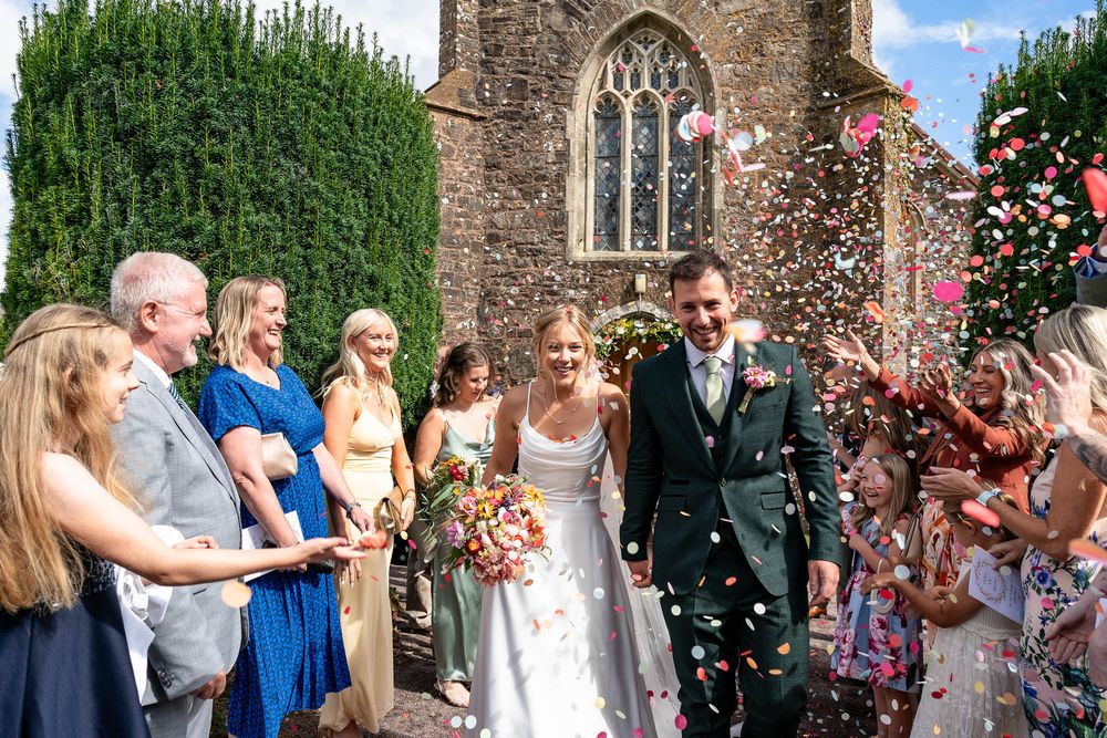 Bride and Groom confetti line Devon Wedding at Stoodleigh Church