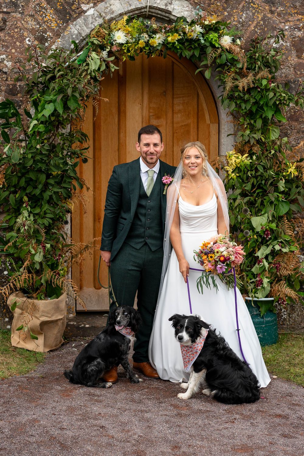 Bride and Groom with two dogs outside Stoodleigh Church