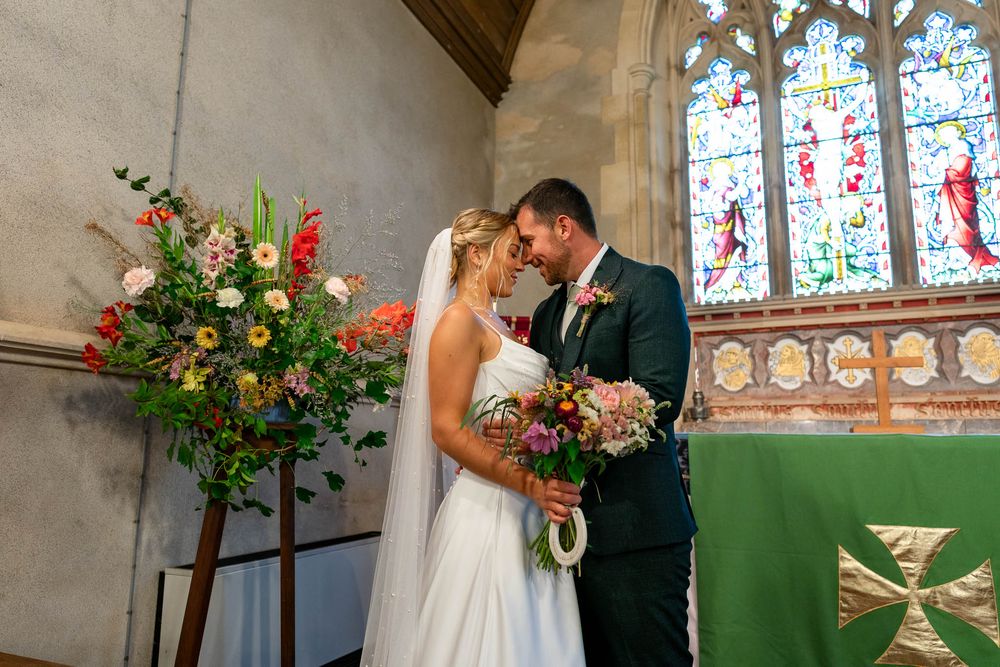 Bride and Groom kissing inside Stoodleigh Church on their Wedding day