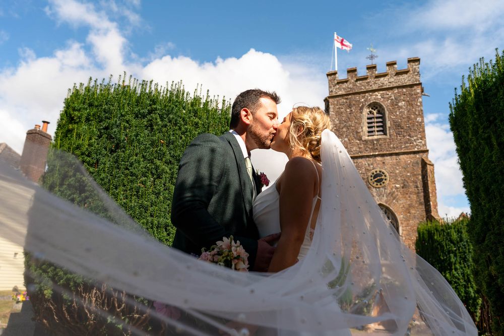 Devon Wedding photographer with Bride and Groom, Stoodleigh Church Devon