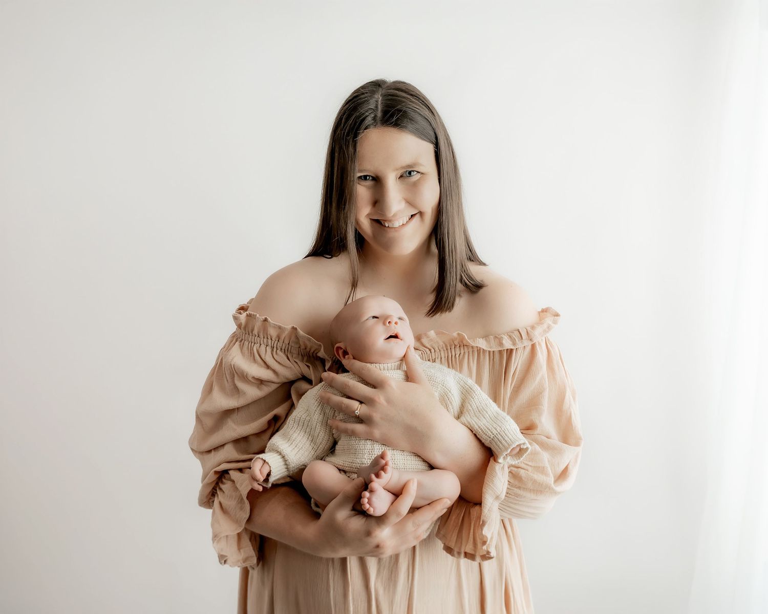 Mother holding newborn baby during portrait session
