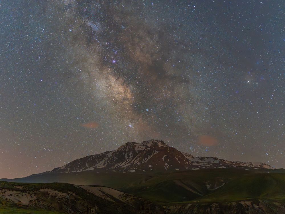 Mount Sabalan, Iran, at night with the Milky Way rising above its snow-streaked summit.