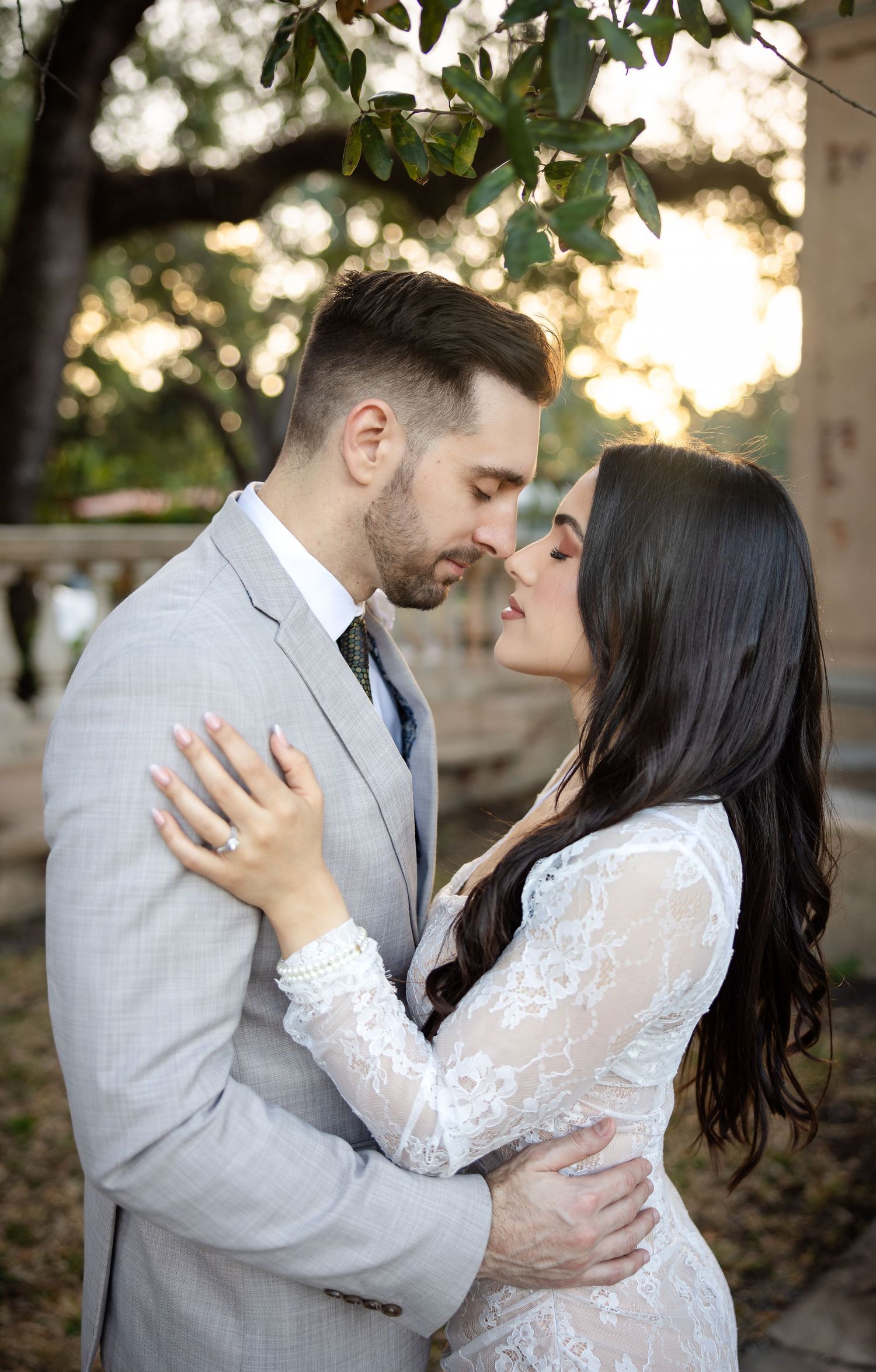 Romantic couple sharing intimate moment in outdoor garden setting.