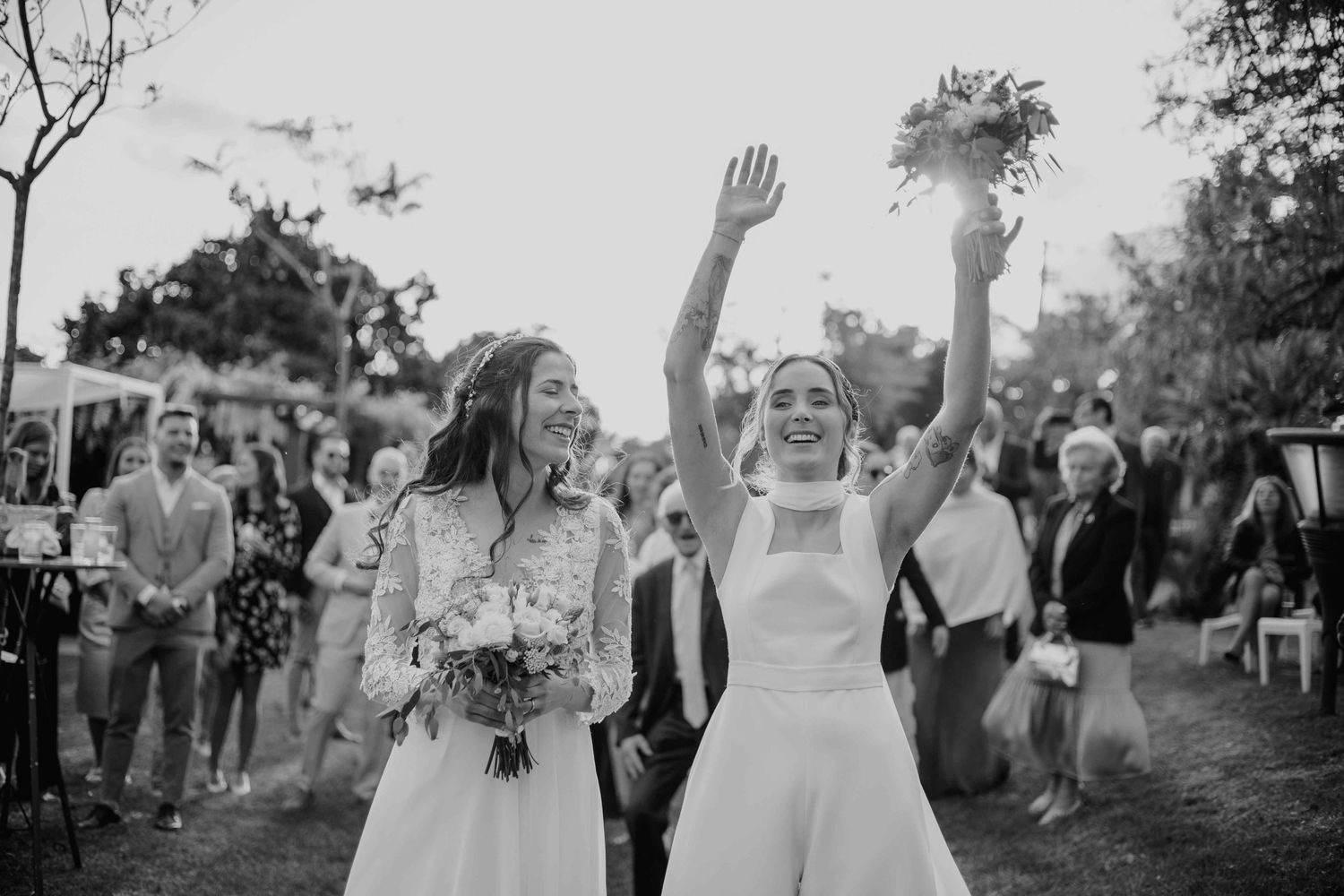 Wedding celebration scene with guests cheering outdoors.