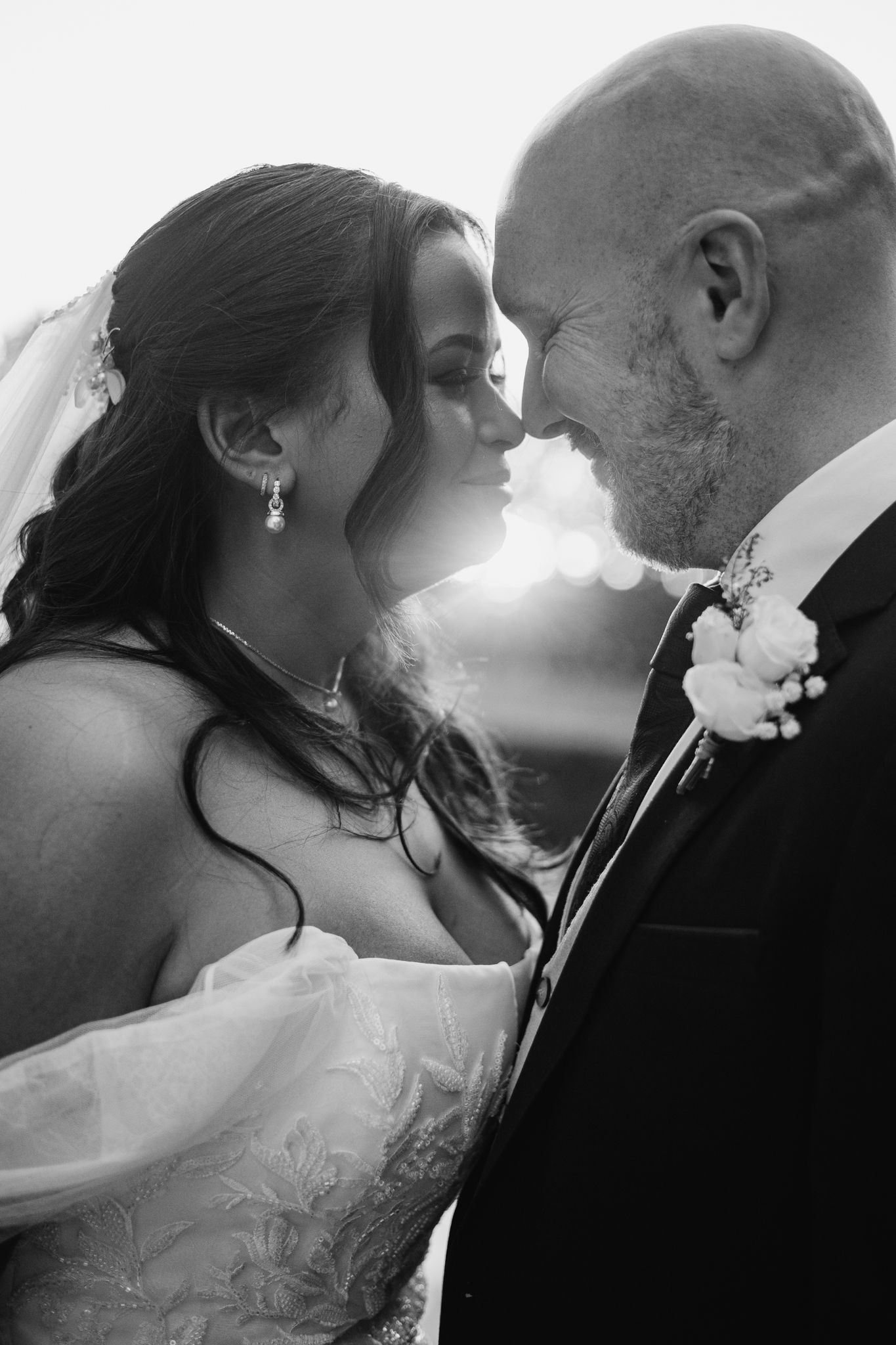 A romantic black and white wedding photography collage showing intimate moments between newlyweds sharing tender kisses.