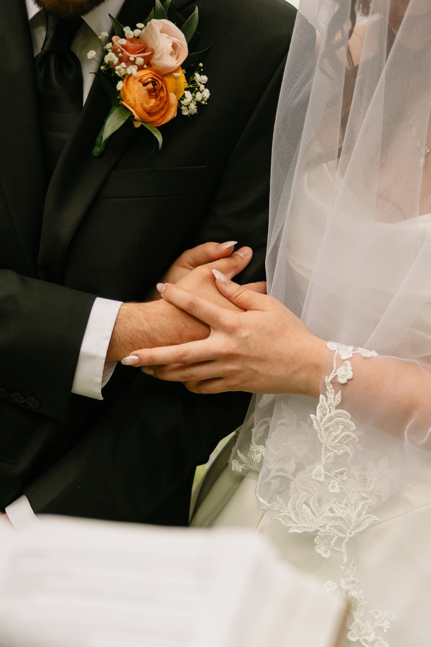 Bride and groom hold hands at The Roost at Butler Farm.