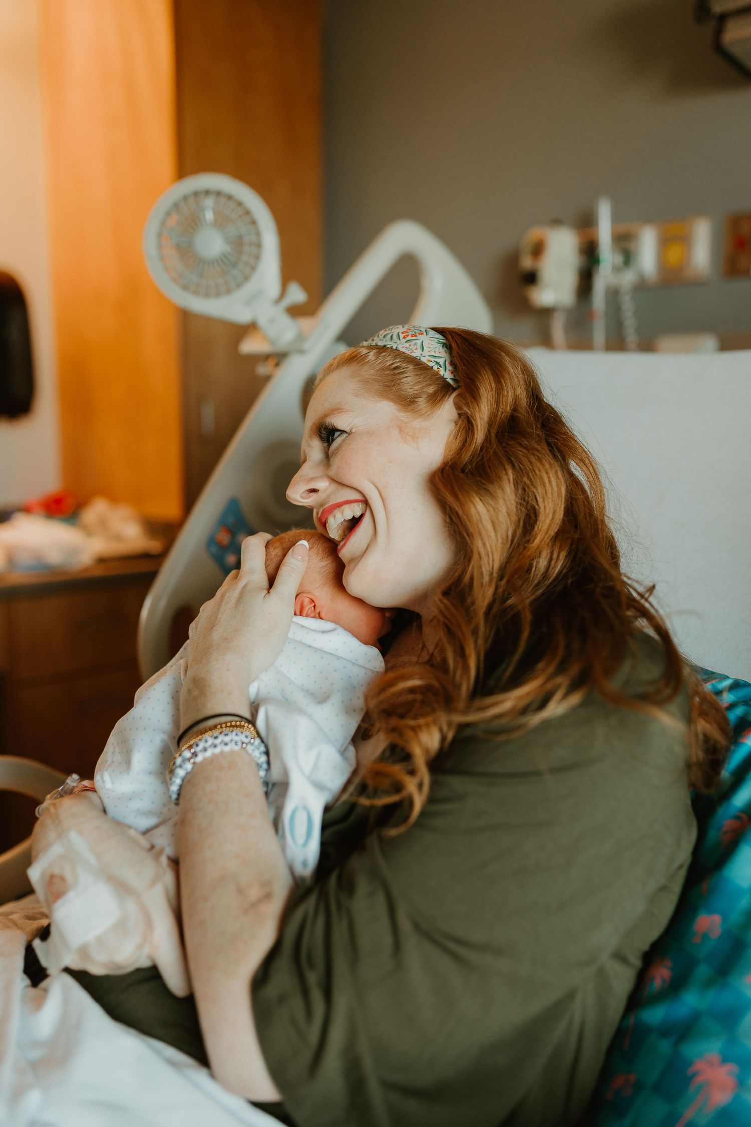 Fresh 48 infant newborn photoshoot held in Spartanburg Regional. Mom snuggling her newborn baby in hospital bed.