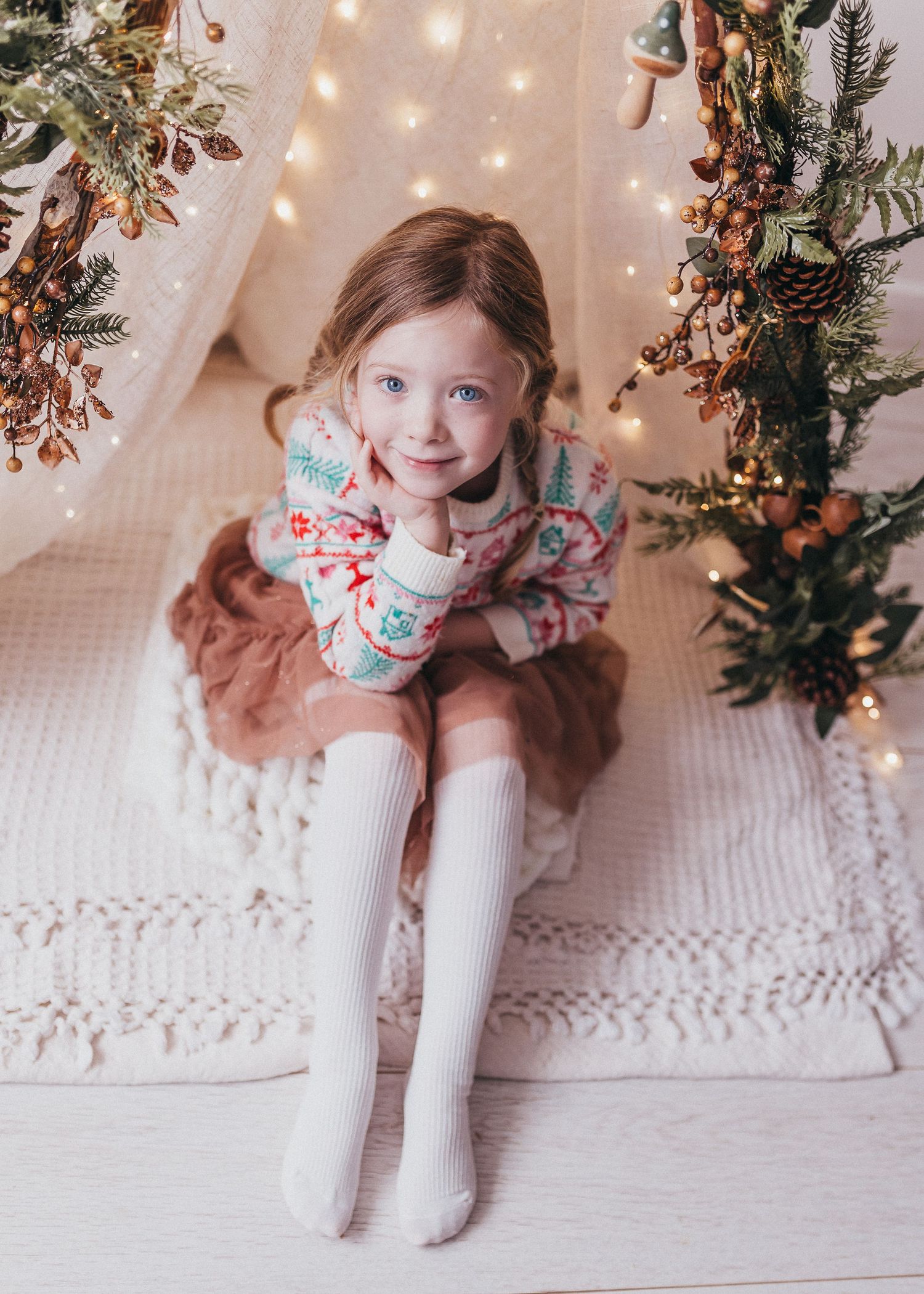 cute christmas cosy photo of little girl in natural winter theme studio boho
