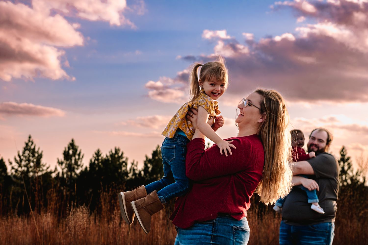 A heartwarming sunset scene showing playtime and laughter in a natural setting.
