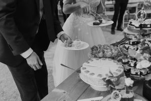 Black and white photo of wedding reception dessert table with elegant cakes and treats.