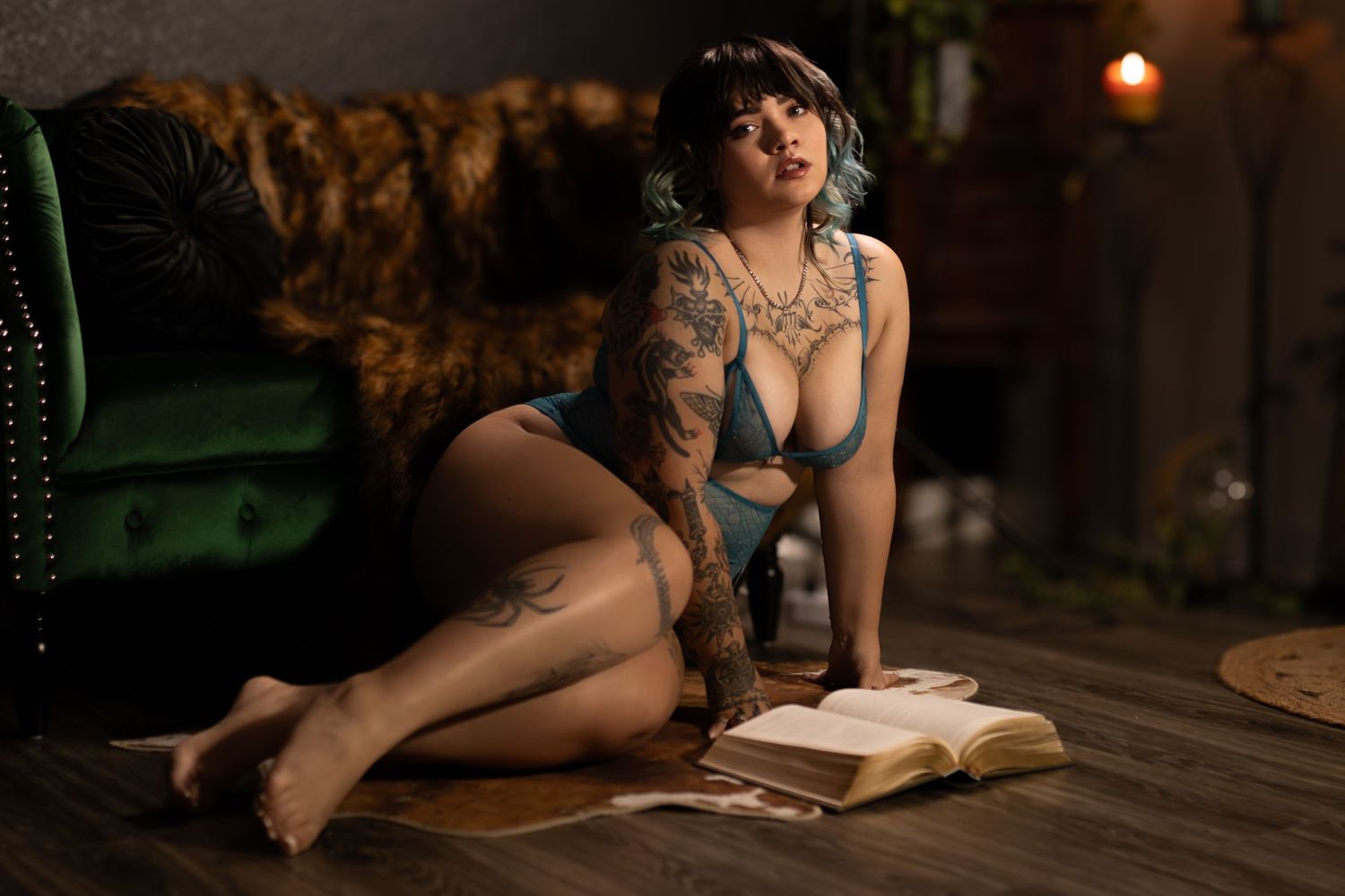 Client in moody boudoir scene, with open book, captured during a fantasy-inspired Fort Worth boudoir session by Lock and Key Photography.