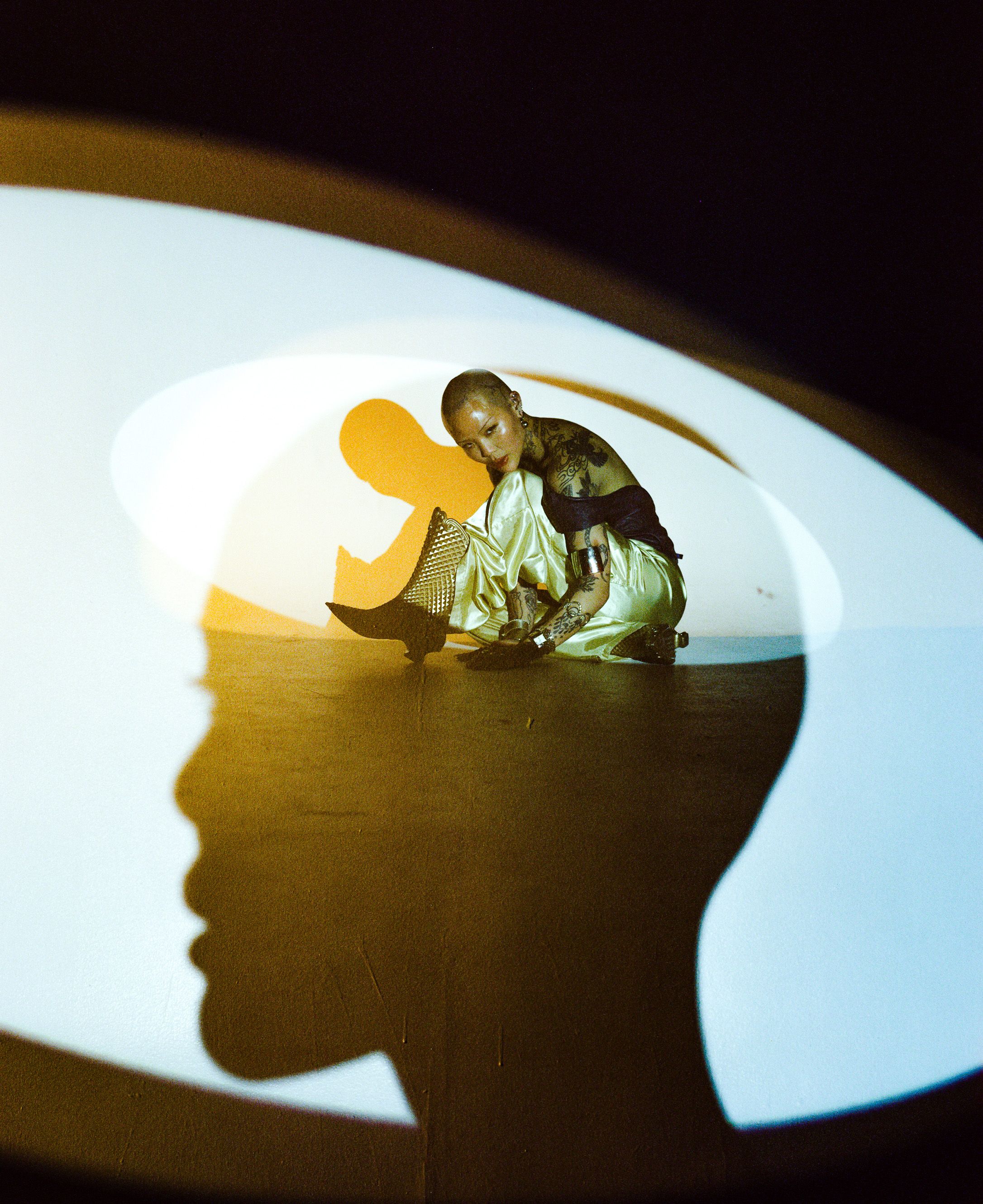 Creative portrait using shadow projection and warm lighting effects.