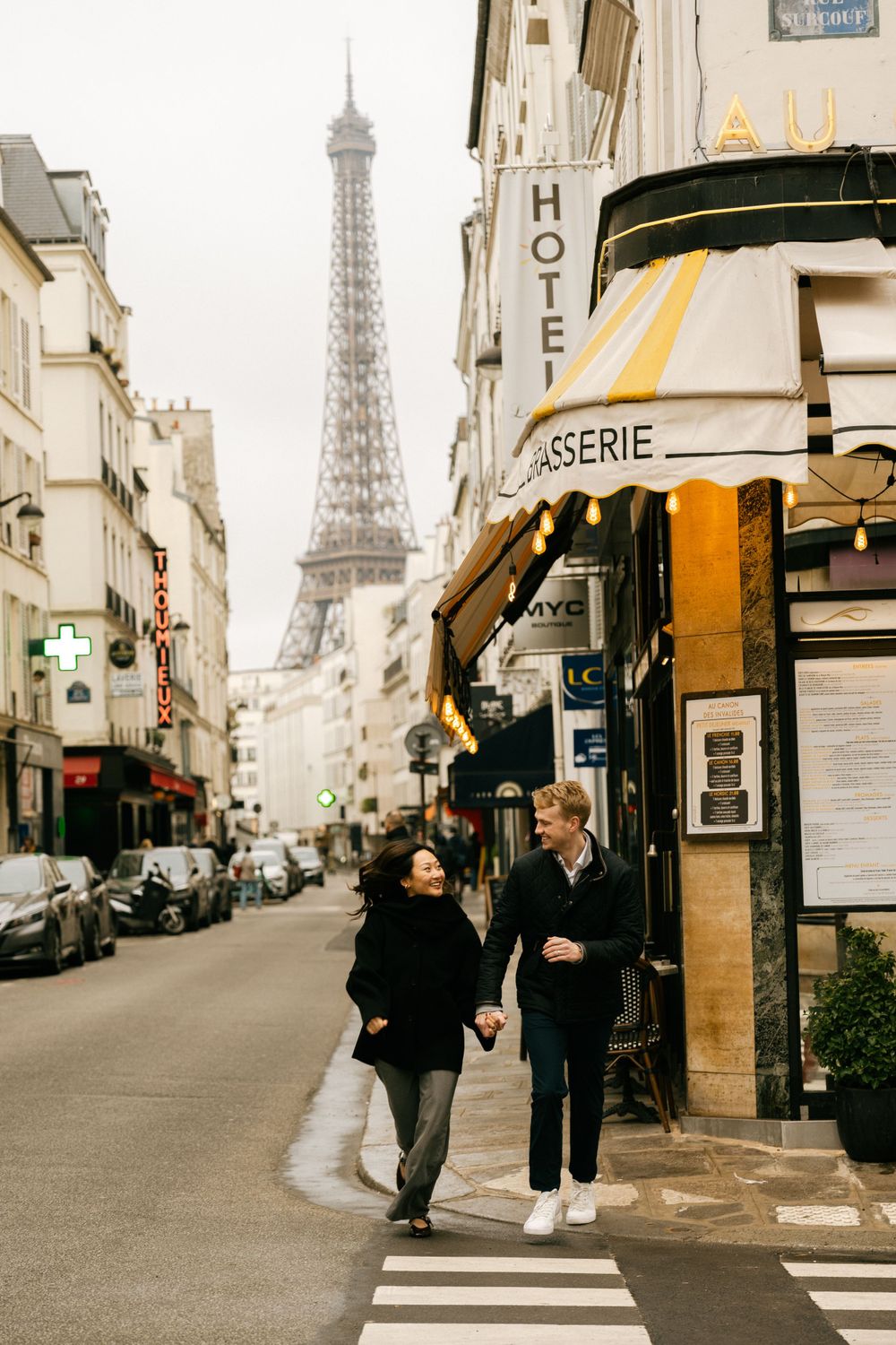 A charming Parisian street scene with the Eiffel Tower in the background and a cozy brasserie cafe on the corner.