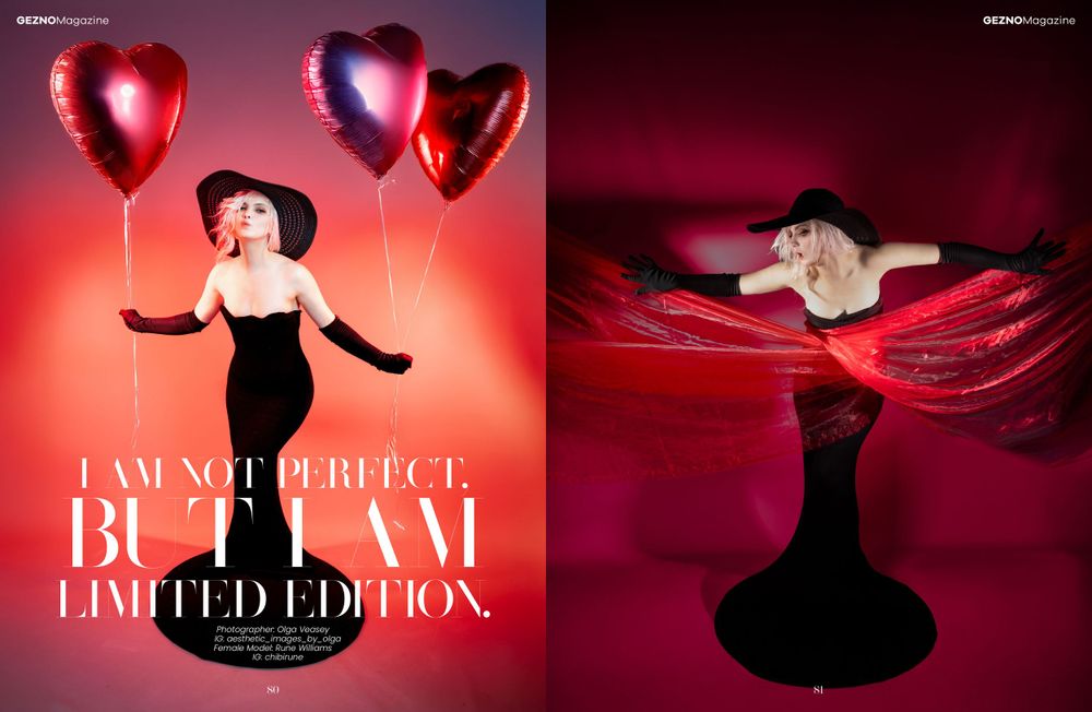 Elegant fashion photoshoot with heart-shaped red balloons and figure on red silk fabric in dramatic lighting.