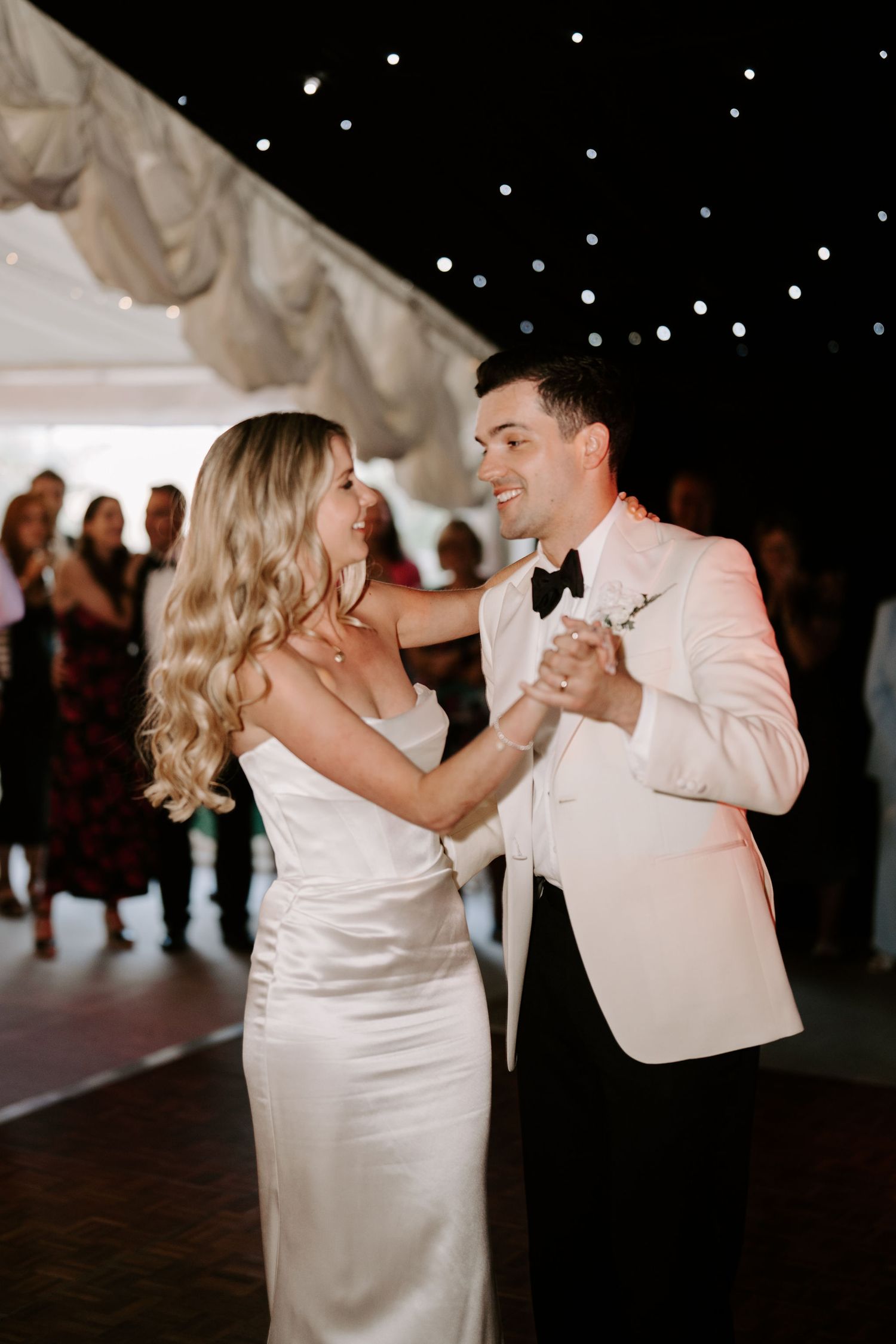 bride and groom doing their first dance surrounded by their wedding guests at hamswell house in bath