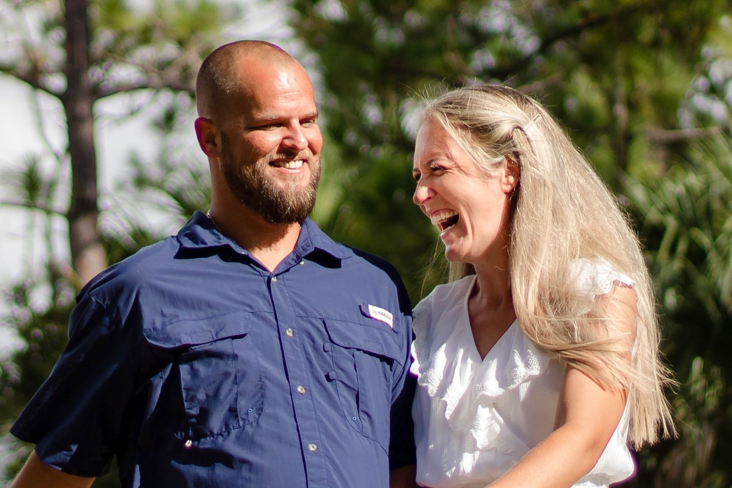 Couple laughing in natural relaxed sunset photo session in Palm Bay