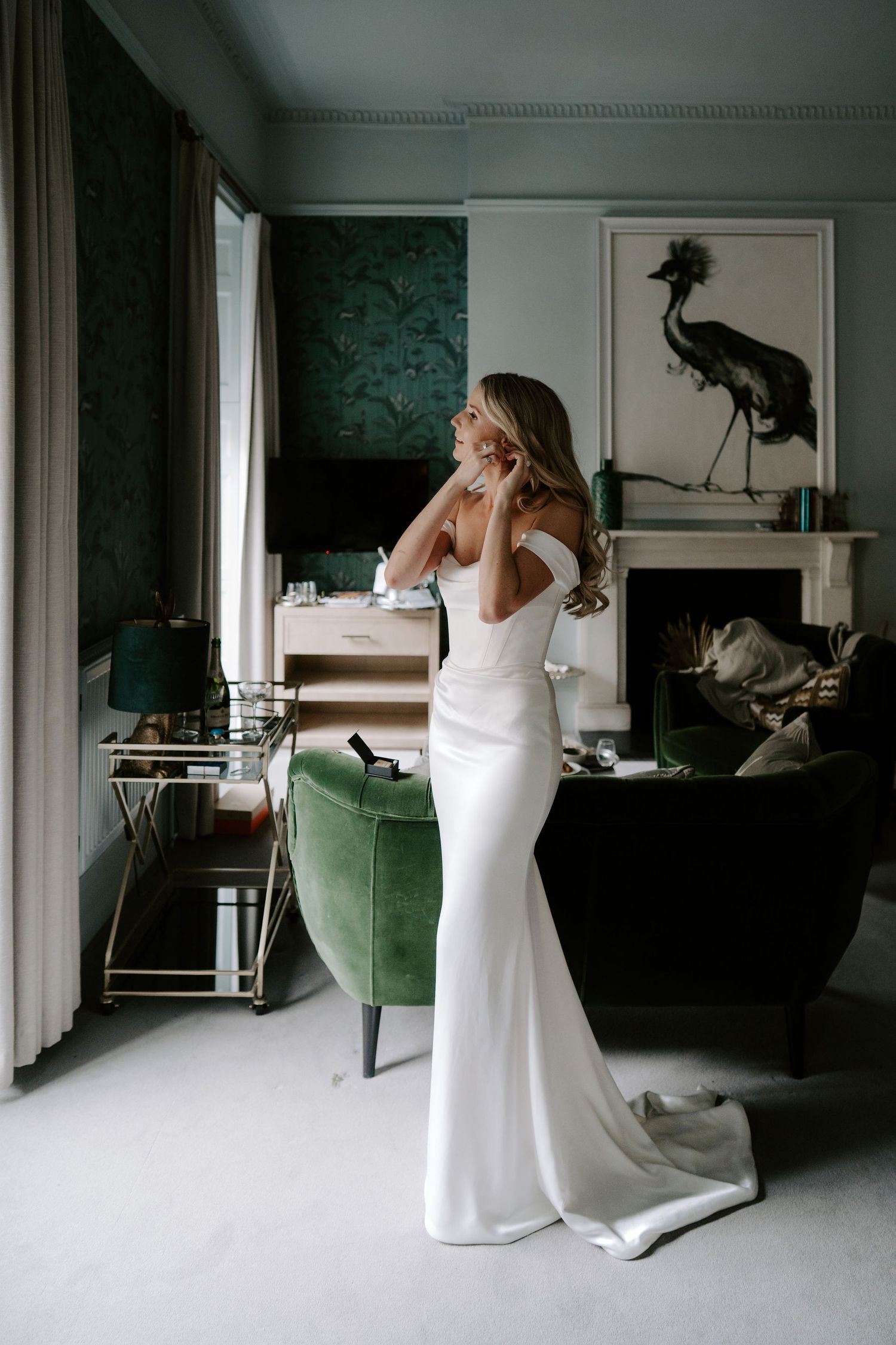 bride putting in earrings getting ready at the Queensbury hotel in bath