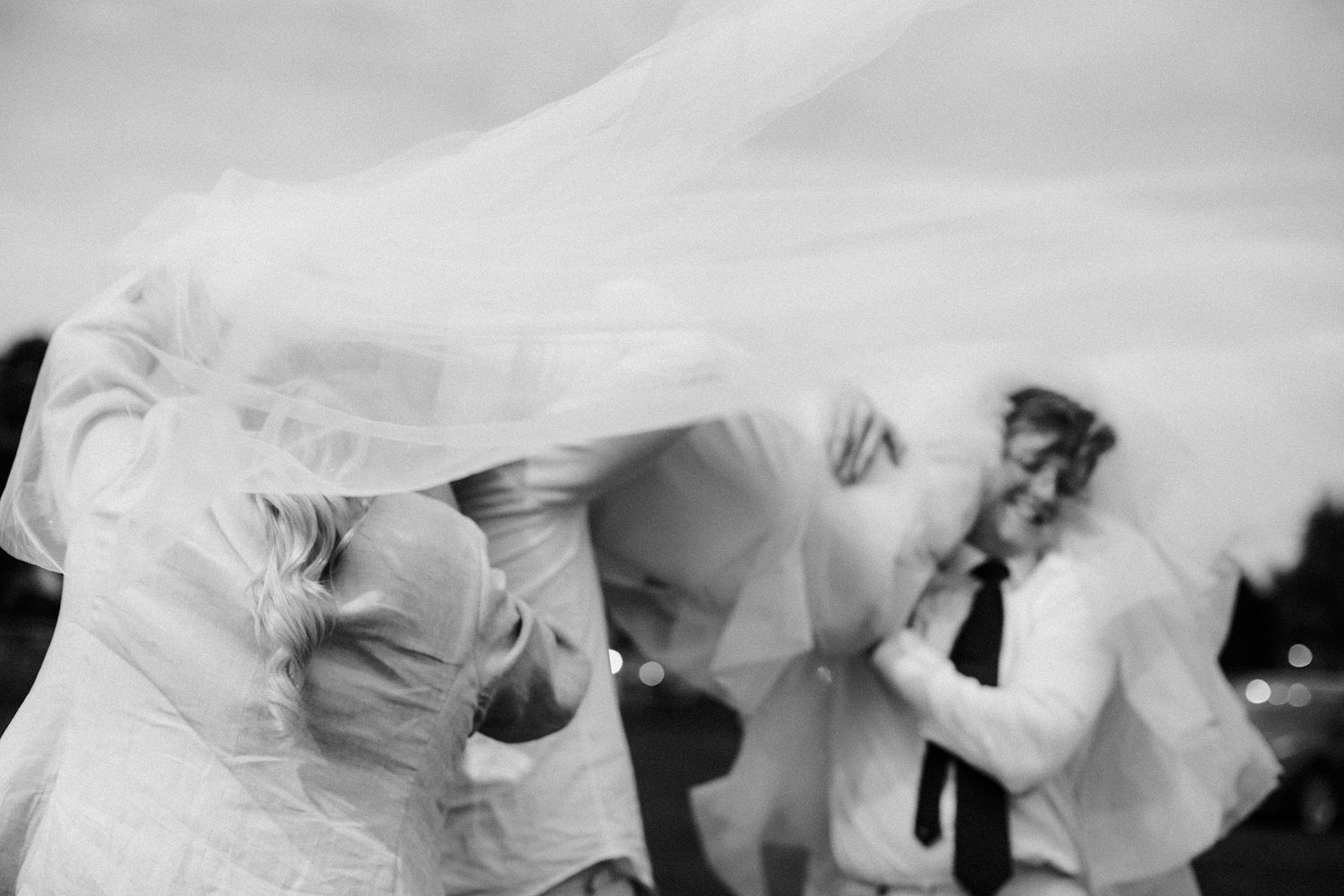 Black and white abstract photograph of bridal party at a celebration at Lightfoot and Wolfville Vineyards in Nova Scotia