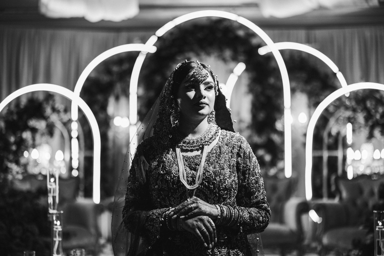 Dramatic black and white photo of a bride in a voluminous ballgown outside a modern building.