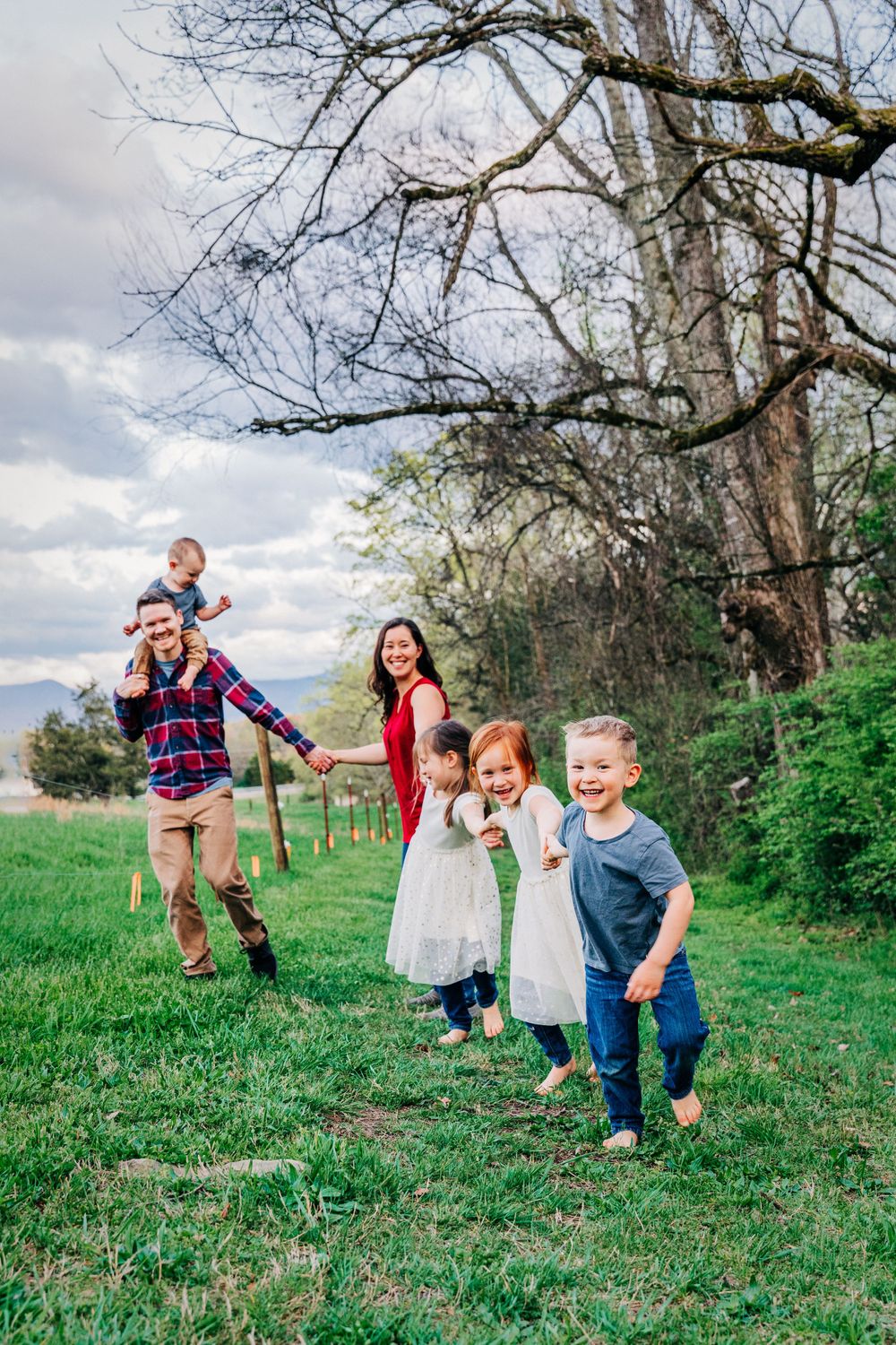 Family portrait session photo of young boy leading the family in follow the leader taken by Jefferson County TN family and photographer