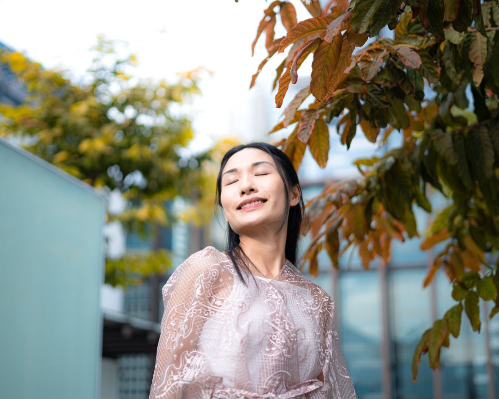 Autumn leaves frame a peaceful moment in a pale pink lace ensemble.