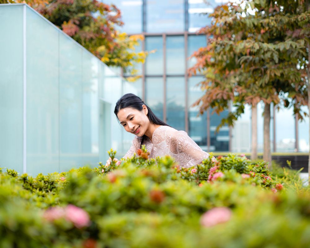 A joyful moment captured among blooming pink flowers and greenery.