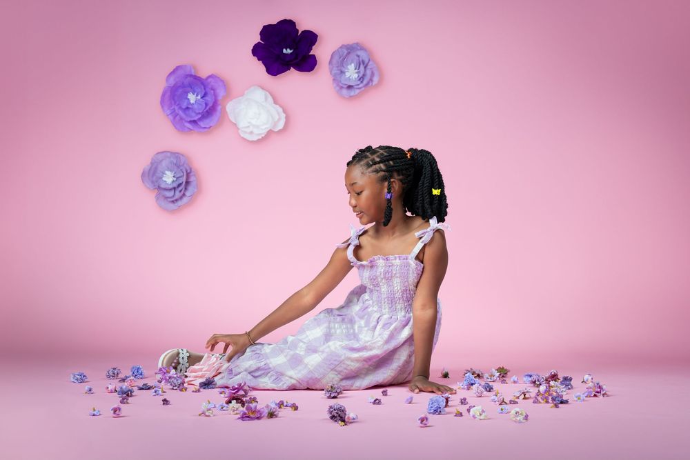 Artistic photo series with purple flowers and white dress against pink background.