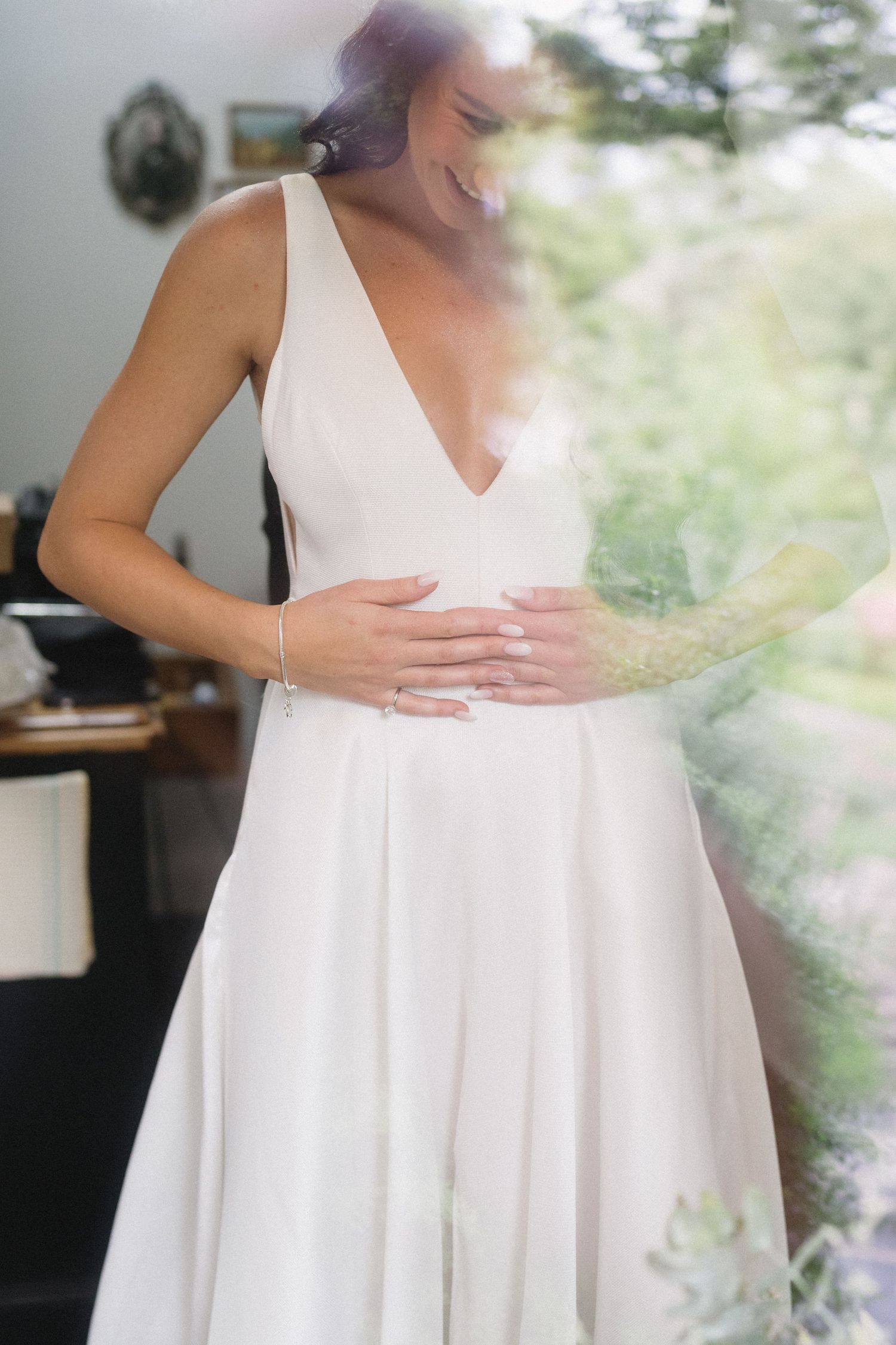 A soft focus image of a white wedding dress in natural window light.
