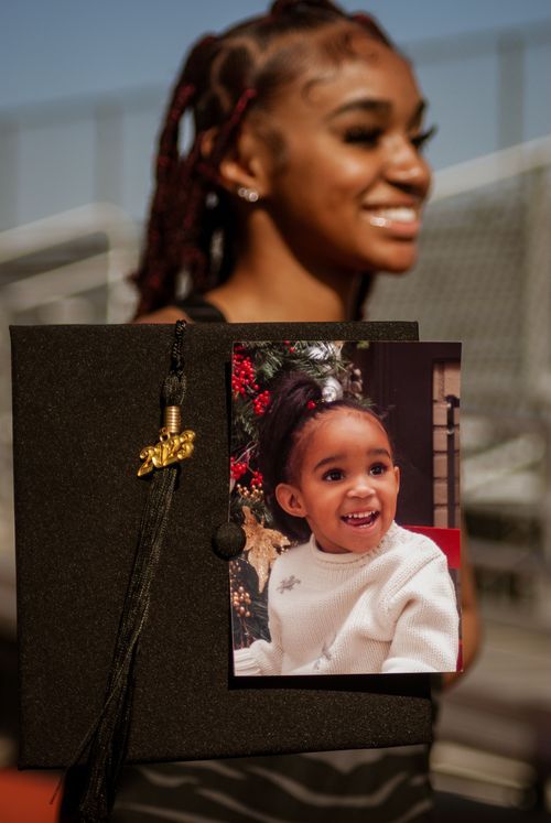 A graduation tassel and photo showing a joyful moment are displayed against a dark background.