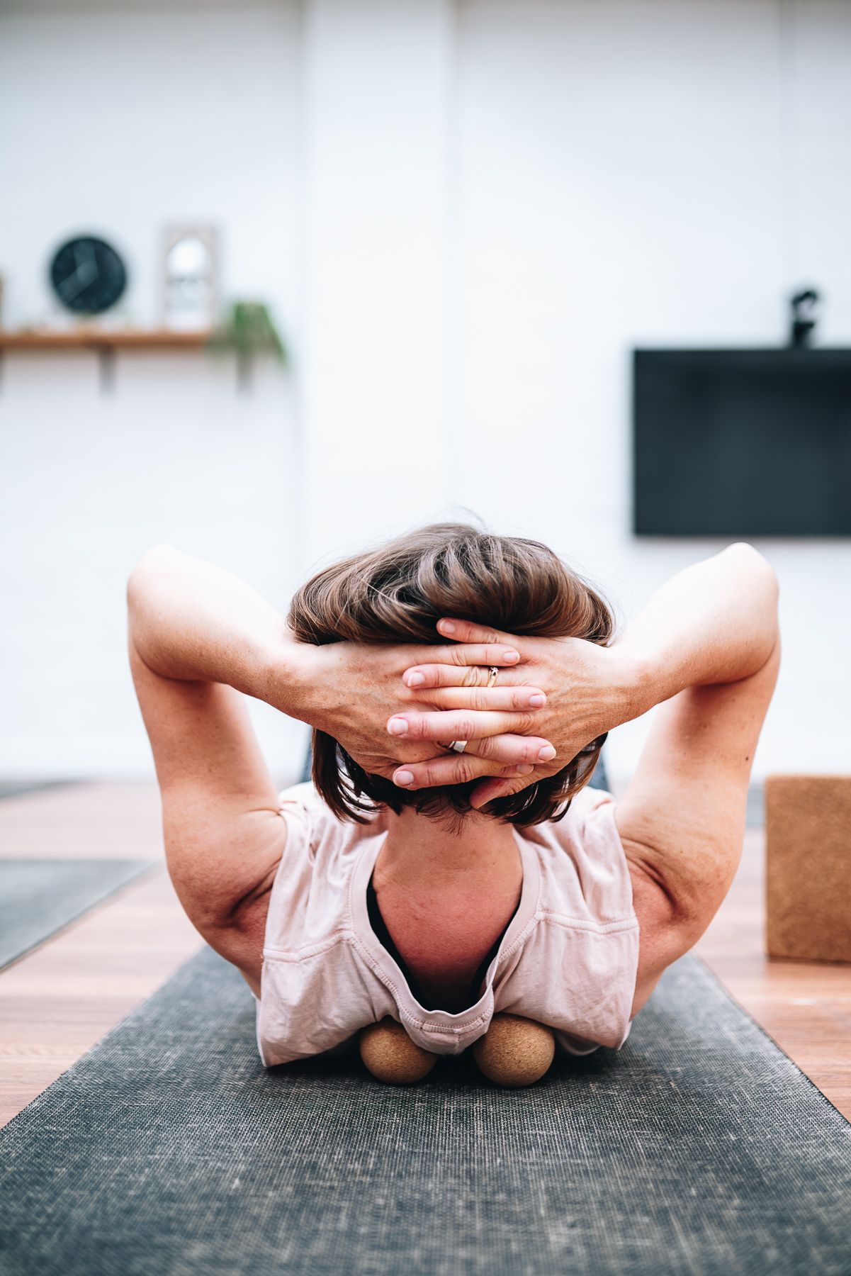 Yoga instructor doing stretched with 2 stretch balls under her back during a professional branding photo session with Melbourne Photographer