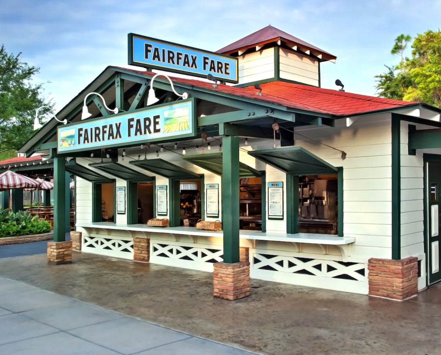 White and green exterior of Fairfax Fare restaurant with covered porch and brick columns.