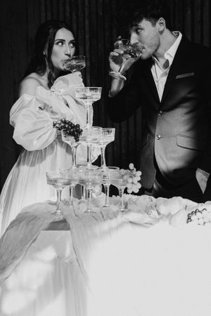Vintage-style wedding reception scene with champagne glasses and elegant place settings.