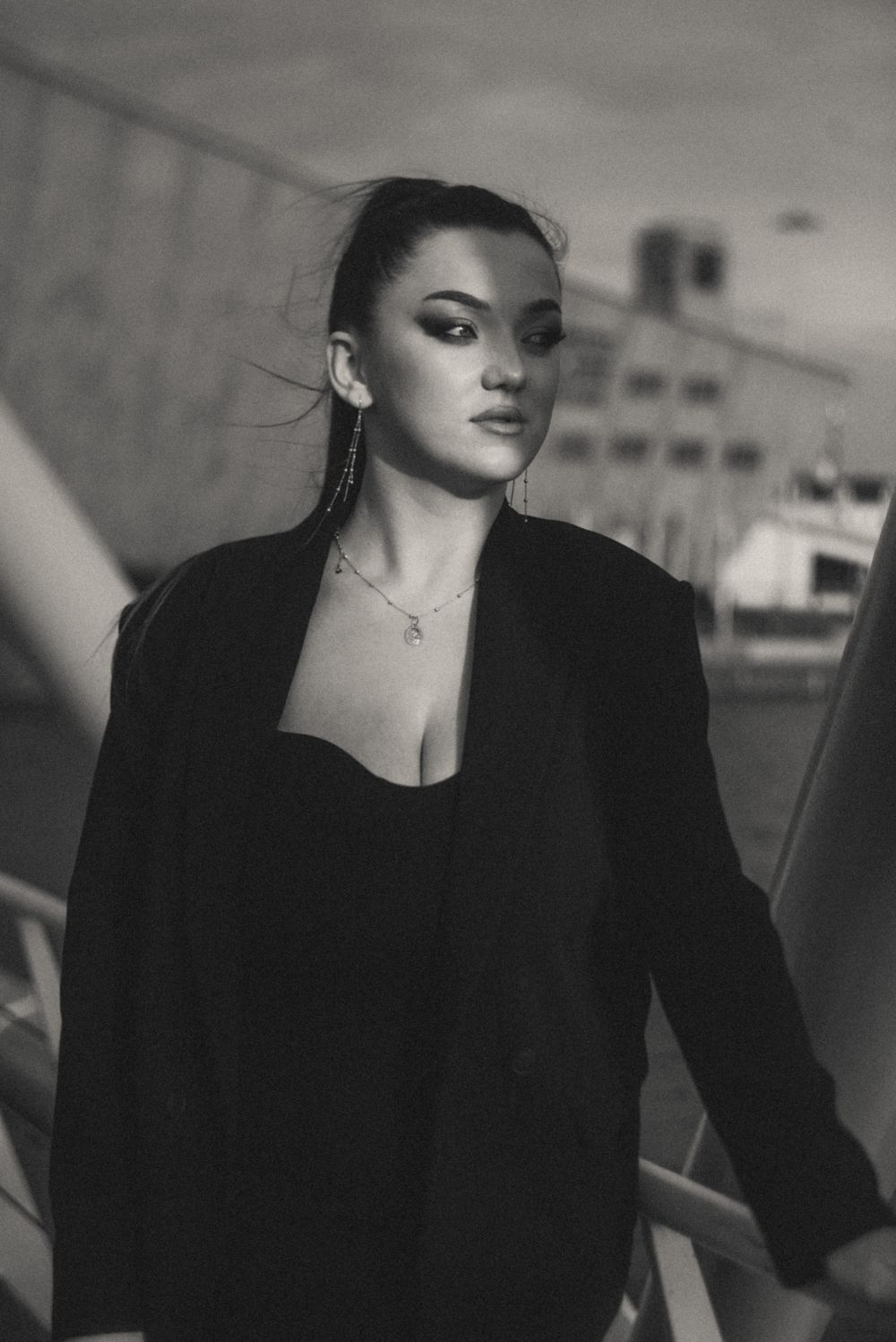 Moody black and white fashion portrait with dramatic shadows and lighting.