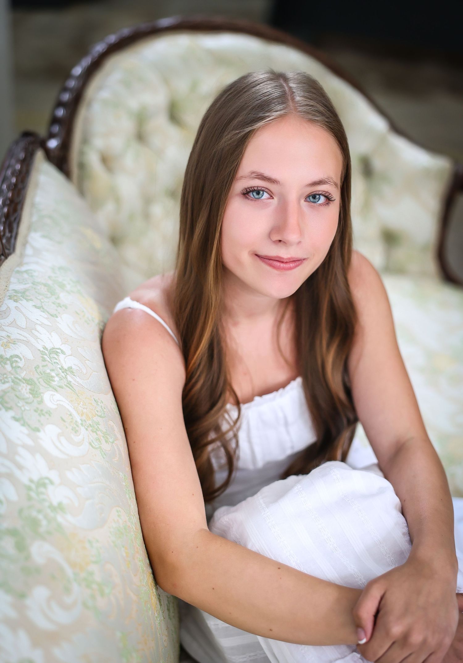 Indoor portrait series with soft lighting against a light colored background.