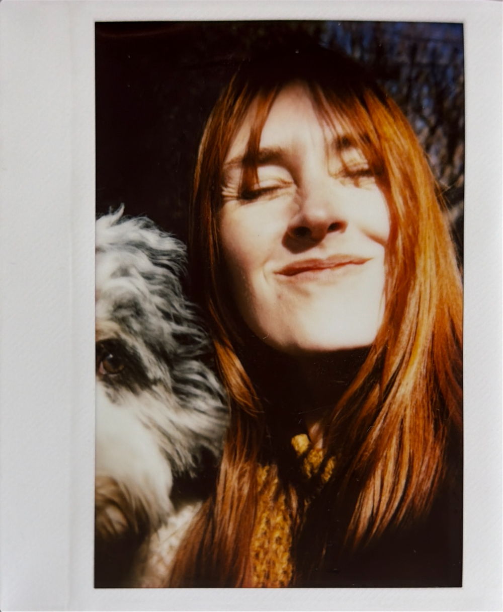 Artistic portrait series showing red-haired figure in moody lighting with fur-trimmed garment.