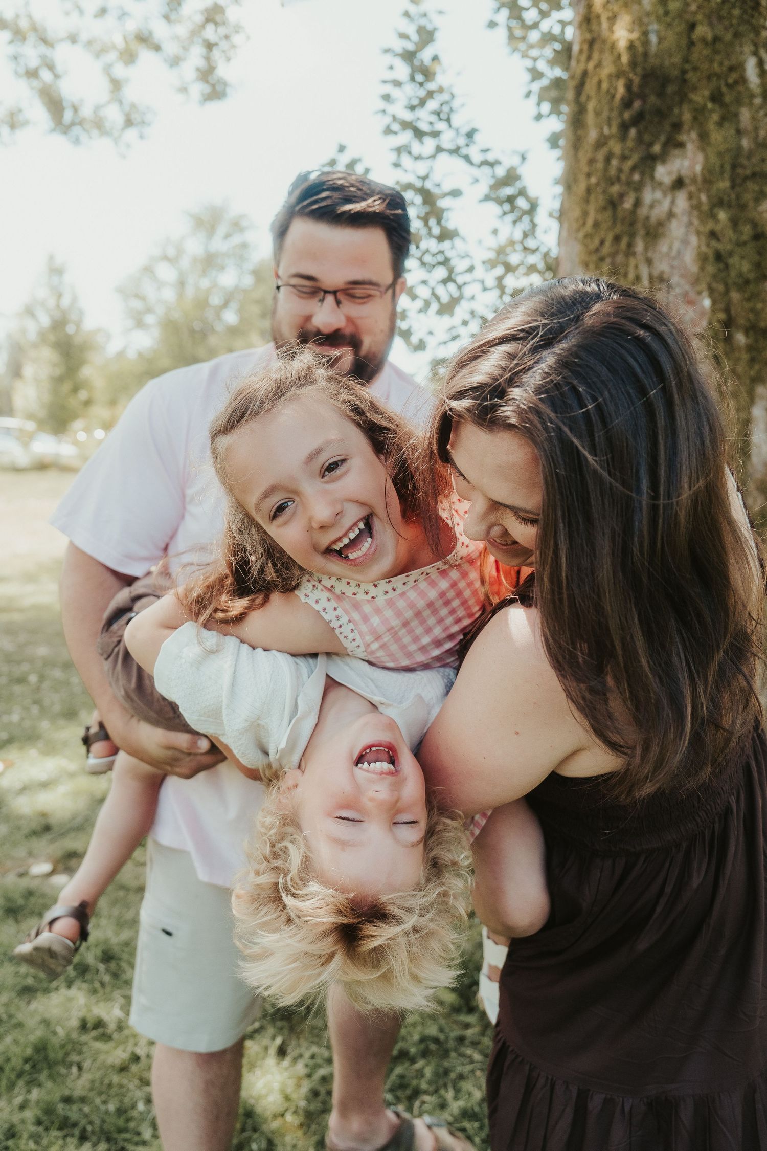 family playing under a blanket on a bed, Victoria, Vancouver Island, BC