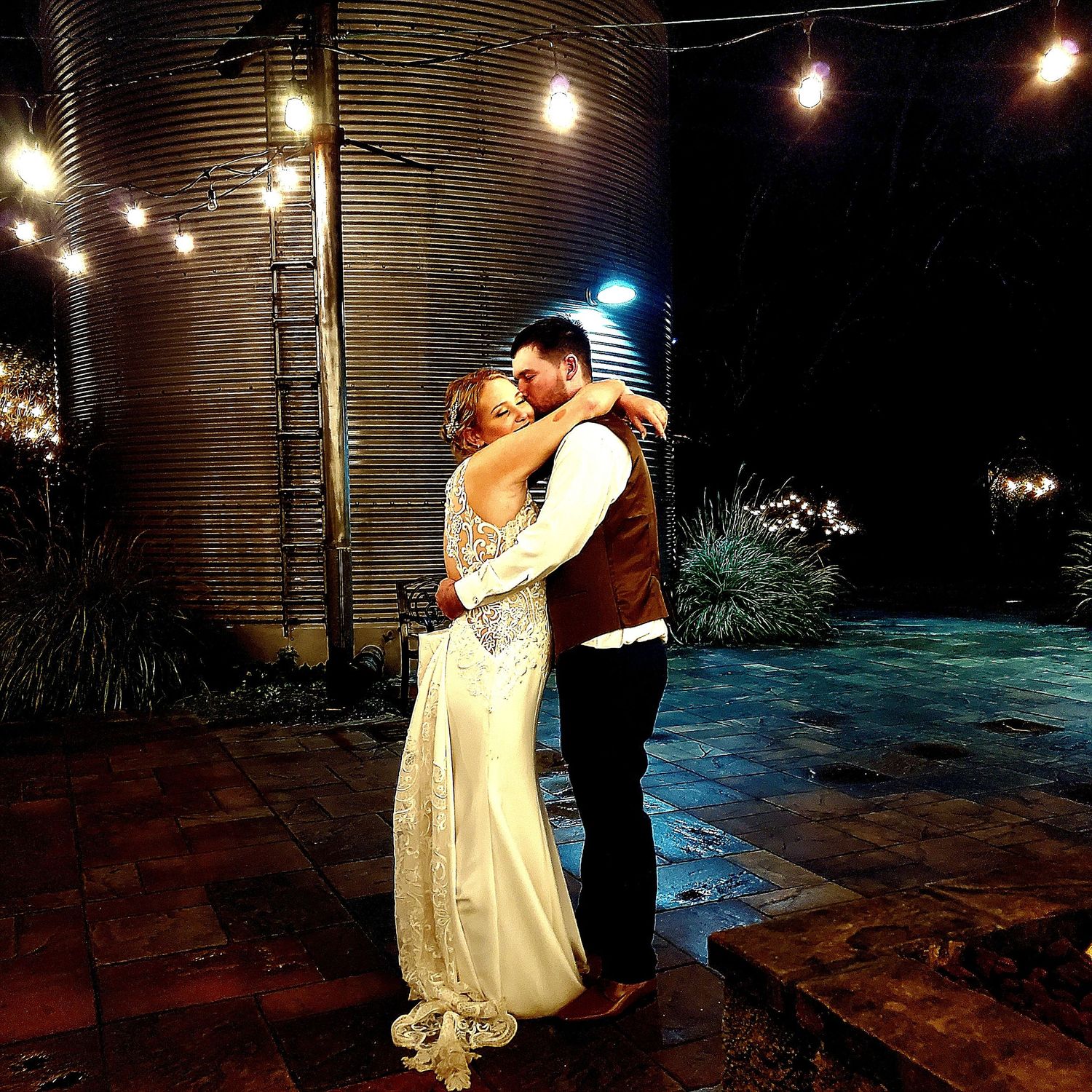 A romantic nighttime dance sequence captured in multiple frames with string lights glowing in the background.