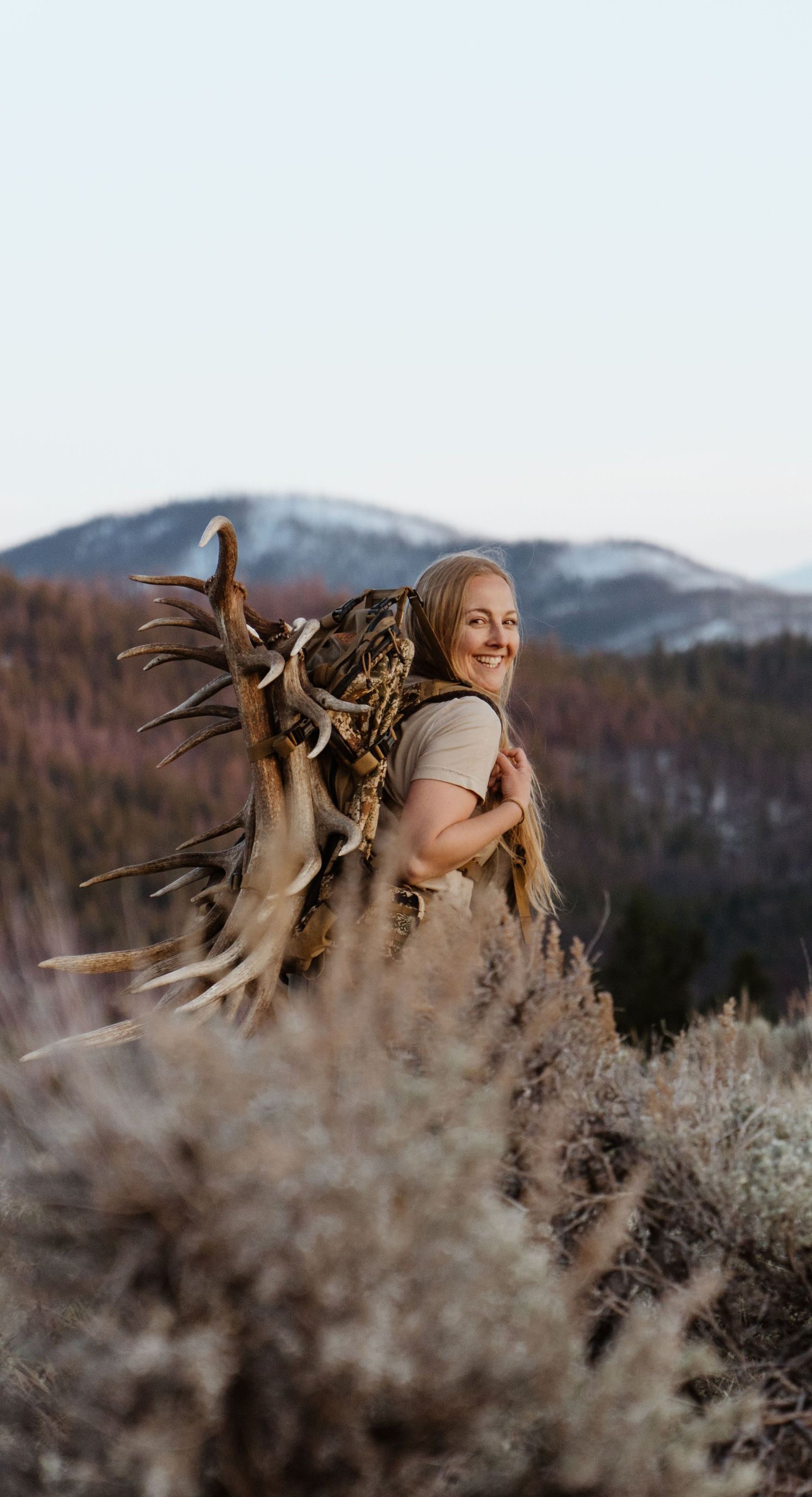 Person with a backpack full of shed elk antlers in montana.