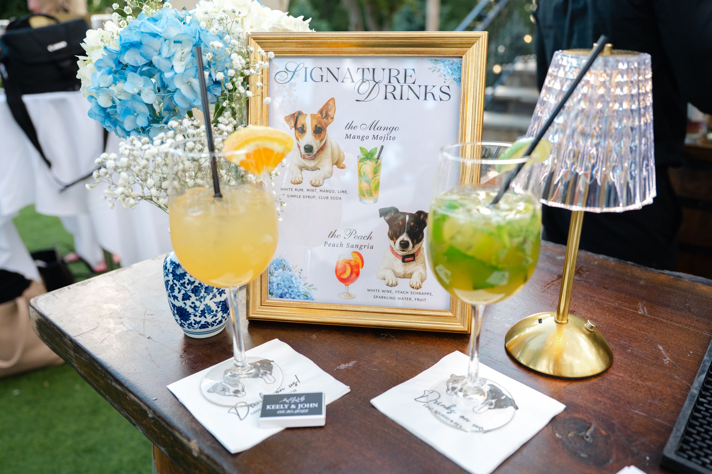 Colorful cocktails and drinks displayed on a wooden table with menu cards and decorative elements.