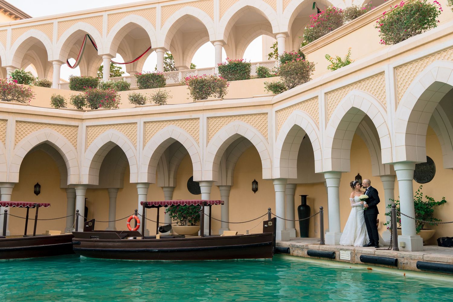 A romantic evening wedding ceremony at Casa Bacardi with a lit floral arch and red carpet walkway.