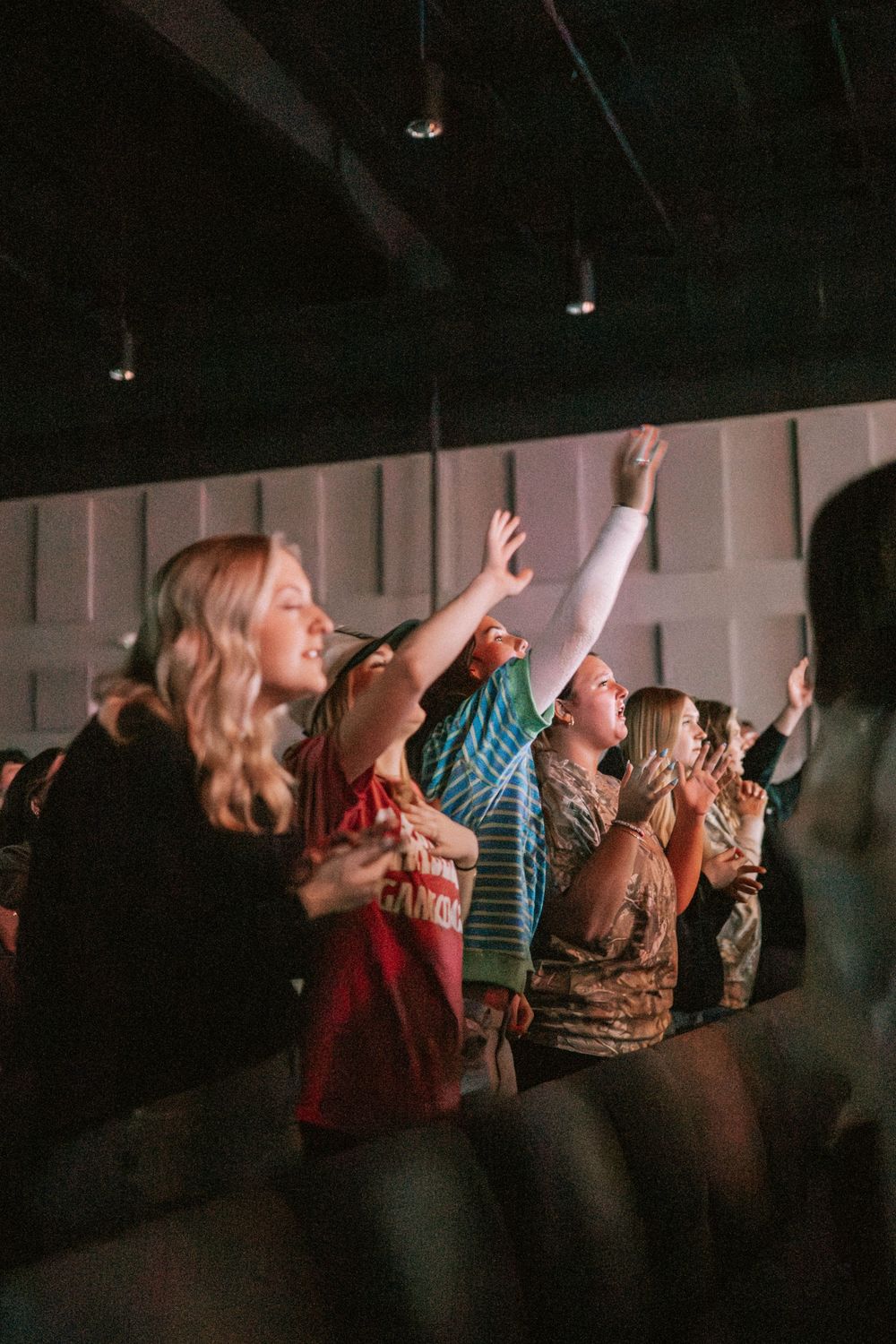 young adults worshipping
