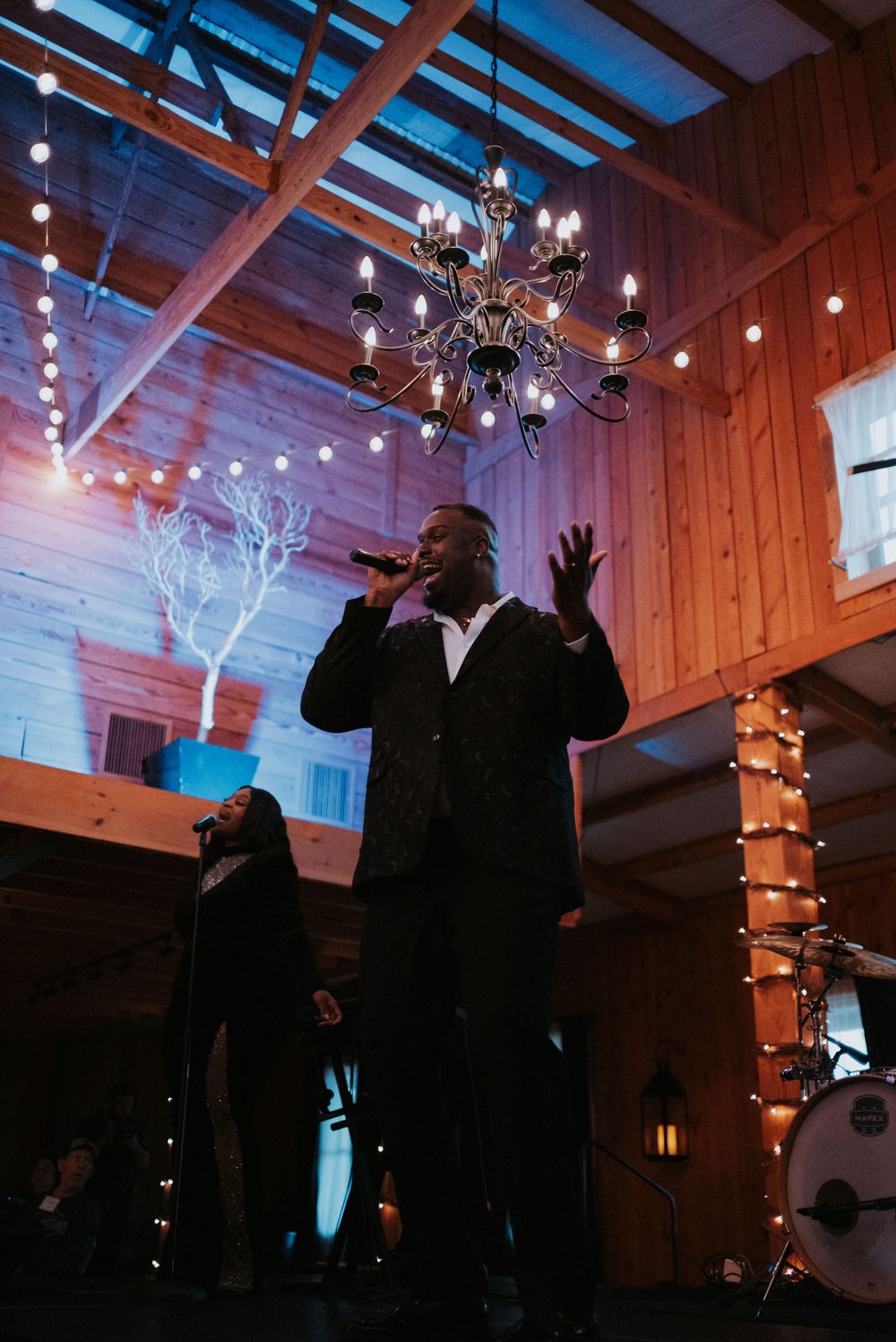 black man singing on stage