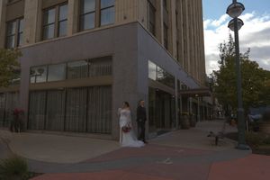 Modern building exterior with glass windows and brick facade.